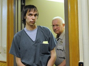 Mason T. Buhl, 16, is escorted at the Lincoln County Courthouse, Thursday, Oct. 1, 2015, in Canton, S.D.  Lincoln County State's Attorney Tom Wollman said Buhl is charged as an adult on one count each of attempted murder and the commission of a felony while armed with a firearm. Buhl is accused of confronting Harrisburg High School Principal Kevin Lein with a handgun in his office Wednesday morning, Sept. 30, and firing a single shot that left the principal with a flesh wound.