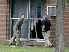 Law enforcement officials investigate an explosion at the Dar Al-Farooq Islamic Center in Bloomington, Minn., on Saturday, Aug. 5, 2017.   Bloomington police Chief Jeff Potts said Saturday that investigators are trying to determine the cause of the blast. Authorities say the explosion damaged one room but it didn't hurt anyone.