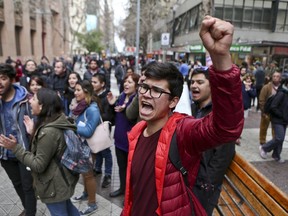 Pro-abortion demonstrators shout slogans outside the Constitutional Court building in Santiago, Chile, Aug. 18, 2017. The court is to decide on a law that legalizes abortion in limited circumstances and end the socially conservative country's status as the last in South America with a blanket ban on the procedure. (AP Photo/Esteban Felix)