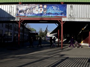 People walk inside the Marcelino Champagnat school, which is run by the Marist Brothers order, in Santiago, Chile, Wednesday, Aug. 30, 2017. The Marist Brothers in Chile say a brother who worked at two of the order's schools abused at least 14 minors from the 1970s until 2000, according to a document obtained Wednesday by The Associated Press. (AP Photo/Esteban Felix)