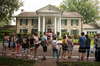 Fans line up outside Graceland, Elvis Presley’s Memphis home, on Aug. 15, 2017, in Memphis, Tennessee.