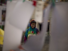 A boy cries as he reads the messages placed on the ground, after a van attack that killed at least 14 people in central Barcelona, Spain, Monday, Aug. 21, 2017. (AP Photo/Emilio Morenatti)