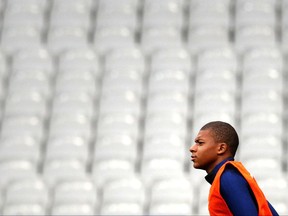 France's Kylian Mbappe, attends a training session at the Stade de France stadium in Saint Denis, north of Paris, France, Wednesday, Aug. 30, 2017. France will play against Netherlands during their World Cup Group A qualifying soccer match on Thursday, Aug.31. (AP Photo/Christophe Ena)