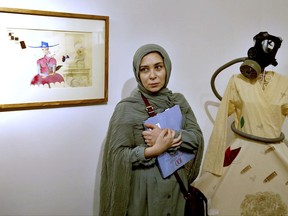 Narges Mousavi an Iranian artist and daughter of Mir Hossein Mousavi stands during her exhibition in "House of Free Designers" art gallery in Tehran, Iran, Friday, Aug. 11, 2017. A daughter of Iran's opposition leader Mir Hossein Mousavi, who has been under house arrest since early 2011, is holding a painting exhibition in Tehran. (AP Photo/Ebrahim Noroozi)