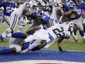 New York Giants defensive end Jason Pierre-Paul (90) tackles New York Jets' Matt Forte (22) for a safety during the first half of a preseason NFL football game Saturday, Aug. 26, 2017, in East Rutherford, N.J. (AP Photo/Julio Cortez)