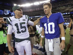 New York Jets' Josh McCown (15) talks with New York Giants' Eli Manning (10) after a preseason NFL football game Saturday, Aug. 26, 2017, in East Rutherford, N.J. The Giants won 32-31. (AP Photo/Julio Cortez)