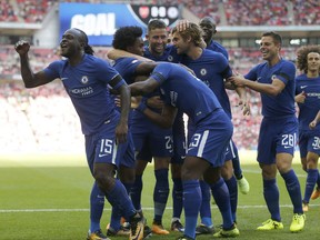Chelsea's Victor Moses, left, celebrates with teammates after scoring his side's first goal during the English Community Shield soccer match between Arsenal and Chelsea at Wembley Stadium in London, Sunday, Aug. 6, 2017. (AP Photo/Frank Augstein)