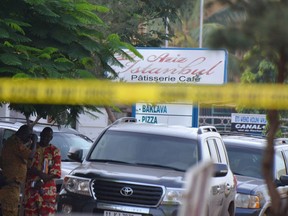 Burkinabe police investigate an area surrounding a restaurant on August 14, 2017 in Ouagadougou, following a deadly attack by gunmen resulting in 18 deaths.