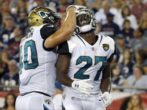 Jacksonville Jaguars running back Leonard Fournette (27) celebrates his touchdown against the New England Patriots with Tommy Bohanon, left, in the first half of an NFL preseason football game, Thursday, Aug. 10, 2017, in Foxborough, Mass. (AP Photo/Mary Schwalm)
