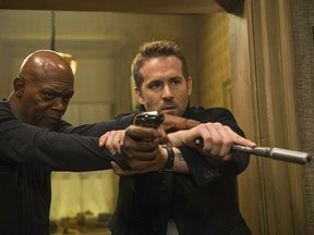 This image released by Lionsgate shows Samuel L. Jackson, left, and Ryan Reynolds in "The Hitman's Bodyguard."