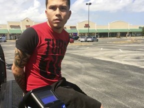 This photo provided by the Orange County Sheriff''s office shows Jocsan Rosado after he was arrested Monday, Aug. 21, 2017 when he parked a stolen car to watch the solar eclipse, in Orlando, Fla. The sheriff's office says he was arrested next to the stolen car, wearing a welding mask and looking up at the sky.(AP Photo via Orange County Sheriff's Office)