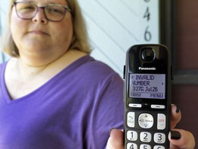 In this Tuesday, Aug. 1, 2017, photo, Jen Vargas shows the data of a recent robocall on her home phone in Orlando, Fla. Vargas has an app for her cellphone that helps locate and block fraudulent calls, although she doesn't know what to do on the home phone other than ignore those calls. (AP Photo/John Raoux)