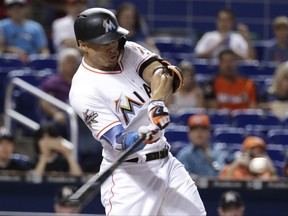Miami Marlins' Giancarlo Stanton hits a single during the first inning of a baseball game against the San Francisco Giants, Tuesday, Aug. 15, 2017, in Miami. (AP Photo/Lynne Sladky)