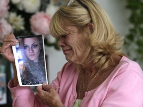 In this Thursday, July 13, 2017 photo, Michelle Holley holds a photograph of her daughter Jaime Holley, 19, who died of a heroin overdose in November 2016, at her home in Fort Lauderdale, Fla. The Reflections treatment center looked like just the place for her youngest daughter to kick heroin. "It looked fine. They were saying all the right things to me. I could not help my child so I trusted them to help my child," Holley said. Instead, the center refused to give 19-year-old Jaime Holley her prescription medicine when she left, forcing her to use illegal drugs to avoid acute withdrawal symptoms, her mother said. (AP Photo/Lynne Sladky)