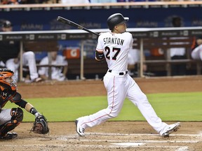 Miami Marlins right fielder Giancarlo Stanton looks on as he hits a solo home run during the third inning of a baseball game against the San Francisco Giants, Tuesday, Aug. 15, 2017 in Miami. (Pedro Portal/Miami Herald via AP)