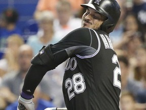 Colorado Rockies' Nolan Arenado reacts after being hit by a pitch during the fifth inning of a baseball game against the Miami Marlins, Sunday, Aug. 13, 2017, in Miami. Major league RBI leader Arenado left the game after being hit by a fastball thrown by Marlins' Vance Worley. (AP Photo/Wilfredo Lee)