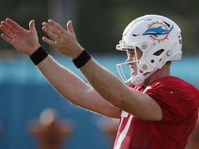 Miami Dolphins quarterback Ryan Tannehill gestures as he runs through drills during an NFL football training camp, Thursday, Aug. 3, 2017, at the Dolphins training facility in Davie, Fla. Tannehill left practice after his left knee appeared to buckle on a scramble and he fell without being hit. (AP Photo/Wilfredo Lee)