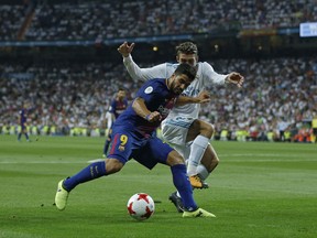 Barcelona's Luis Suarez, left, vies for the ball with Real Madrid's Mateo Kovacic during the Spanish Super Cup second leg soccer match between Real Madrid and Barcelona at the Santiago Bernabeu stadium in Madrid, Wednesday, Aug. 16, 2017. (AP Photo/Francisco Seco)