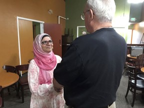 In this July 10, 2017 photo, Moina Shaiq speaks to a man after a Meet a Muslim event at Bronco Billy's Pizza Palace in Fremont, Calif. Shaiq discussed the importance of the hijab, the head scarf, and the niqab, the face covering, as well as the differences between Sunnis and Shias. She also spoke about the rights of women in Islam, and what it's like to be an American-Muslim today in her one-hour talks. (AP Photo/Kristin J. Bender)