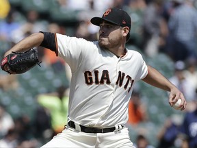 San Francisco Giants pitcher Matt Moore throws against the Milwaukee Brewers during the first inning of a baseball game in San Francisco, Wednesday, Aug. 23, 2017. (AP Photo/Jeff Chiu)