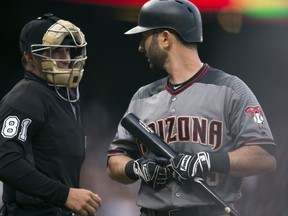 Arizona Diamondbacks' Daniel Descalso (3) questions home plate umpire Quinn Wolcott after he was called out on strikes during the first inning of the team's baseball game against the San Francisco Giants on Saturday, Aug. 5, 2017, in San Francisco. (AP Photo/D. Ross Cameron)