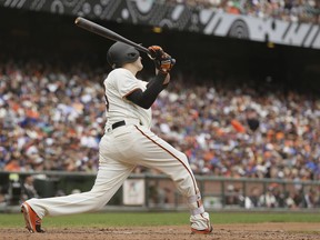 San Francisco Giants' Jarrett Parker hits an RBI single off Chicago Cubs relief pitcher Brian Duensing in the seventh inning of a baseball game Wednesday, Aug. 9, 2017, in San Francisco. (AP Photo/Eric Risberg)