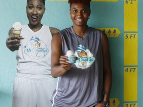 WNBA player with the Atlanta Dream Angel McCoughtry stands next to a photo of herself inside her recently opened ice cream shop, "McCoughtry's," located in metropolitan Atlanta. The two-time Olympic gold medalist is sitting out the 2017 WNBA season to recover physically from playing year-round in the U.S. and overseas for eight years. (AP Photo/Andy Buhler)