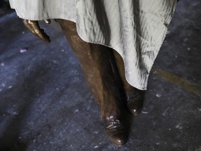 In this Thursday, Aug. 24, 2017 photo, a statue sculpted by artist Martin Dawe paying tribute to civil rights leader Martin Luther King Jr., stands covered at his studio in Atlanta. More than three years after Georgia lawmakers endorsed the project, a statue paying tribute to King will be installed and unveiled on the state Capitol grounds Monday, Aug. 28. (AP Photo/David Goldman)