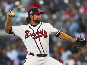Atlanta Braves starting pitcher R.A. Dickey (19) works in the first inning of a baseball game against the Seattle Mariners Wednesday, Aug. 23, 2017, in Atlanta. (AP Photo/John Bazemore)