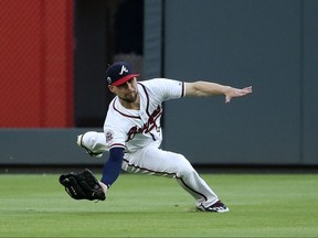 Atlanta Braves center fielder Ender Inciarte (11) makes a catch to retire Los Angeles Dodgers' Cody Bellinger in the first inning of a baseball game Tuesday, Aug. 1, 2017, in Atlanta. (AP Photo/John Bazemore)