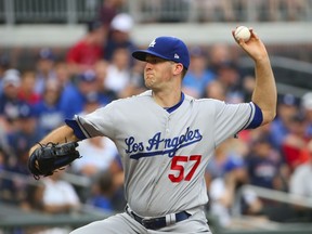 Los Angeles Dodgers starting pitcher Alex Wood works against the Atlanta Braves during the first inning of a baseball game Thursday, Aug. 3, 2017, in Atlanta. (AP Photo/John Bazemore)