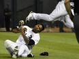 Willy Garcia of the Chicago White Sox is kneed by teammate Yoan Moncada during MLB action Monday night in Chicago.