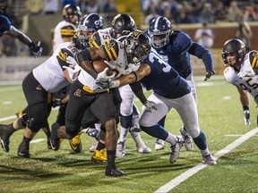 FILE - In this Oct. 27, 2016, file photo, Appalachian State running back Jalin Moore (25) maneuvers around Georgia Southern's defensive line in an NCAA college football game in Statesboro, Ga. Appalachian State returns Moore, who rushed for 1,402 yards last season and was named the Sun Belt's offensive player of the year. (Josh Galemore/Savannah Morning News via AP, File)