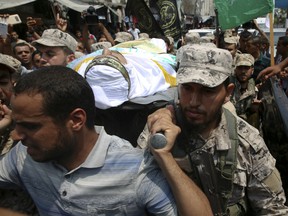 Hamas border security force members carry the body of their colleague of Nidal al-Jaafari during his funeral in Rafah refugee camp, Gaza Strip, Thursday, Aug. 17, 2017. Al-Jaafari was killed when a man trying to cross into Egypt blew himself up.