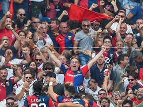 Genoa players celebrate after Juventus' Miralem Pjanic scored an own goal, during a Serie A soccer match between Genoa and Juventus, at the Luigi Ferraris Stadium in Genoa, Italy, Saturday, Aug. 26, 2017. (Simone Arveda/ANSA via AP)