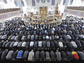 In this Sept. 10, 2010 file photo Muslims pray at a mosque for the Eid al-Fitr holiday, which marks the end of the holy Muslim fasting month of Ramadan in Duisburg, western Germany.