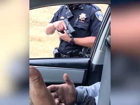 A Campbell, Calif. police officer points his gun at a man for what the occupants of the vehicle said was more than nine minutes.