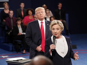Hillary Clinton writes about her loss in an upcoming book, including this moment in a debate on Oct. 9, 2016, when Donald Trump stood behind her. She writes that it made her "skin crawl."