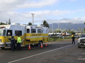 The Honolulu Fire Department Command Center is seen at a boat harbor, Wednesday, Aug. 16, 2017 in Haleiwa, Hawaii. An Army helicopter with five on board crashed several miles off Oahu's North Shore late Tuesday. Rescue crews are searching the waters early Wednesday. (AP Photo/Marco Garcia)