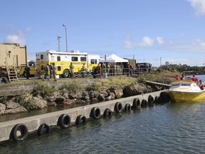 The Honolulu Fire Department Command Center is mobilized at a boat harbor, Wednesday, Aug. 16, 2017, in Haleiwa, Hawaii. An Army helicopter with five on board crashed several miles off Oahu's North Shore late Tuesday. Rescue crews are searching the waters early Wednesday. (AP Photo/Marco Garcia)