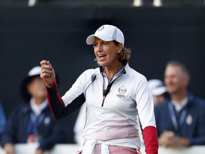 U.S. captain Juli Inkster dances on the first tee before the start of foursomes match play in the Solheim Cup golf tournament, Saturday, Aug. 19, 2017, in West Des Moines, Iowa. (AP Photo/Charlie Neibergall)