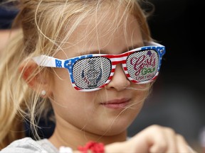 A young fan waits for an autograph during practice for the Solheim Cup golf tournament, Thursday, Aug. 17, 2017, in West Des Moines, Iowa. (AP Photo/Charlie Neibergall)