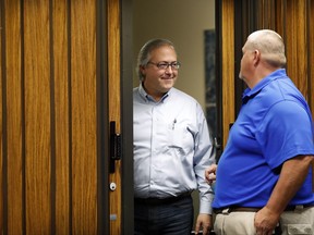 In this Wednesday, Aug. 2, 2017 photo, U.S. Rep. David Young, R-Iowa, speaks with a local resident during a stop at the Glenwood City Hall, in Glenwood, Iowa. Conservatives in Young's district are angry with the GOP's failure to repeal and replace Obamacare. Independents don't like the partisan approach. And now Democrats are making an issue of Young's vote for a health care bill that President Donald Trump called "mean." (AP Photo/Charlie Neibergall)