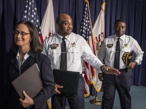 In this Tuesday, Aug. 29, 2017 photo, Chicago Police Superintendent Eddie Johnson, center,  leaves a press conference in Chicago, acknowledging a reporter who wished him well for his kidney transplant surgery scheduled for Wednesday. Johnson disclosed in January after suffering a public dizzy spell that he has battled for decades a potentially life-threatening inflammation of his kidneys and was on a waiting list for a kidney transplant. Johnson's 25-year-old son is donating one of his kidneys to his father. (Rich Hein/Sun Times via AP)