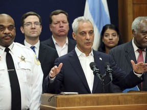 In this Aug. 6, 2017 photo, Chicago Mayor Rahm Emanuel, accompanied by Police Superintendent Eddie Johnson, left, and U.S. Rep. Danny Davis, right, announces a lawsuit against the Trump Justice Department over withholding funding for sanctuary cities at City Hall in Chicago. At least six so-called sanctuary cities are suing the U.S. government, over immigration-related policies to avoid losing millions in public safety dollars the Trump administration has threatened to withhold. (Brian Cassella/Chicago Tribune via AP)