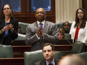 Illinois State Rep. Will Davis, D-Homewood, watches the votes come in on the education funding bill he sponsored on the floor of the Illinois House during a special session at the Illinois State Capitol, Monday, Aug. 28, 2017, in Springfield, Ill. The Illinois House approved an education funding plan Monday that will increase state money for all districts, reduce disparities between rich and poor schools and provide $75 million in tax credits for people who donated to private school scholarships. (Justin L. Fowler/The State Journal-Register via AP)