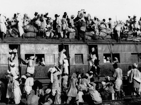 In this September 1947, file photo hundreds of Muslim refugees crowd on top a train leaving New Delhi for Pakistan. After Britain ended its colonial rule over the Indian subcontinent, two independent nations were created in its place _ the secular, Hindu-majority nation of India, and the Islamic republic of Pakistan. The division, widely referred to as Partition, sparked massive rioting that killed up to 1 million, while another 15 million fled their homes in one of the world's largest ever human migrations. (AP Photo, File)