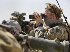 A Belgian special forces soldiers looks through his binoculars near the frontline, east of Tal Afar, Iraq, Sunday, Aug. 20, 2017. Iraqi forces have launched a multi-pronged assault to retake the town of Tal Afar, west of Mosul, marking the next phase in the country's war on the Islamic State group. Tal Afar and the surrounding area is one of the last pockets of IS-held territory in Iraq after victory was declared in July in Mosul, the country's second-largest city. (AP Photo/Balint Szlanko)