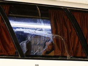 An Islamic State fighter looks out the window of a bus in a convoy transporting ISIL members and their families across Syria, on Aug. 28, 2017.