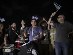 Meni Naftali, centre, and Eldad Yaniv, far right, are the main organizers of a weekly protest against Israeli Prime Minister Benjamin Netanyahu.